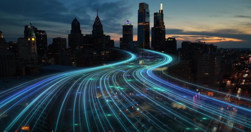 Smart city digital transformation development concept. Band lights over modern urban cityscape at night. New fast internet communication 5G technology. Fiber Optics